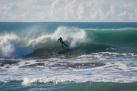 Surfing photo at Wainui Beach in Gisborne showing Guy Edge Burns doing a forehand hack on his surfboard