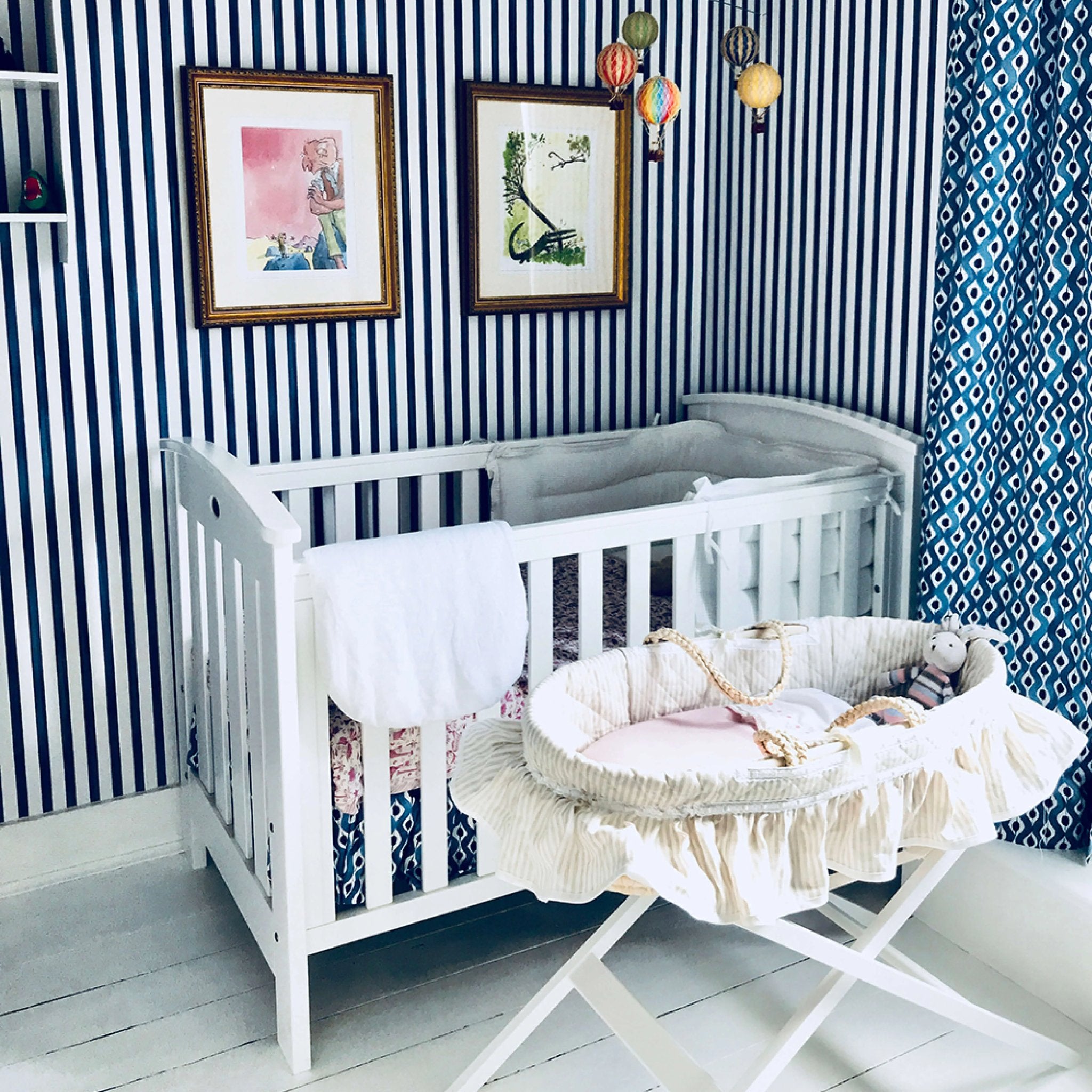 nursery with blue stripes and white cot