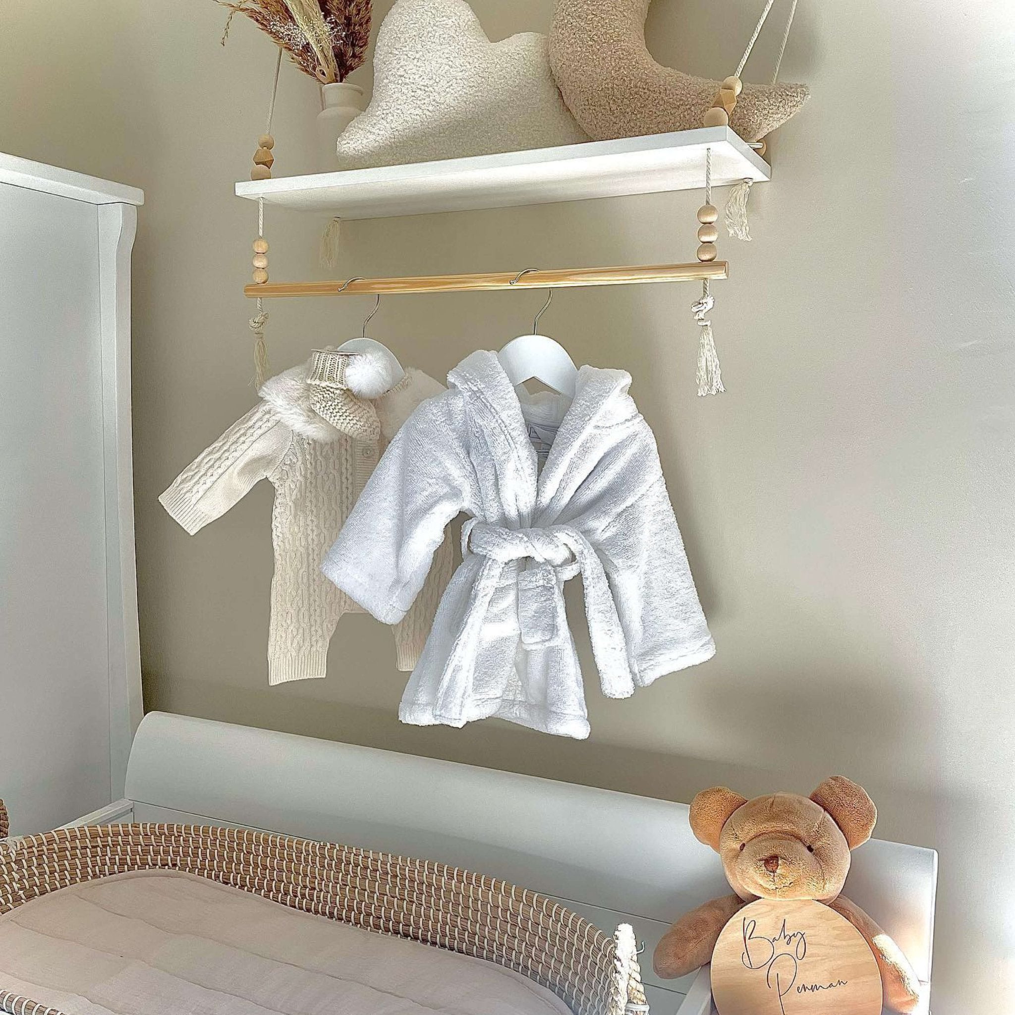 baby dressing gowns hanging above change table