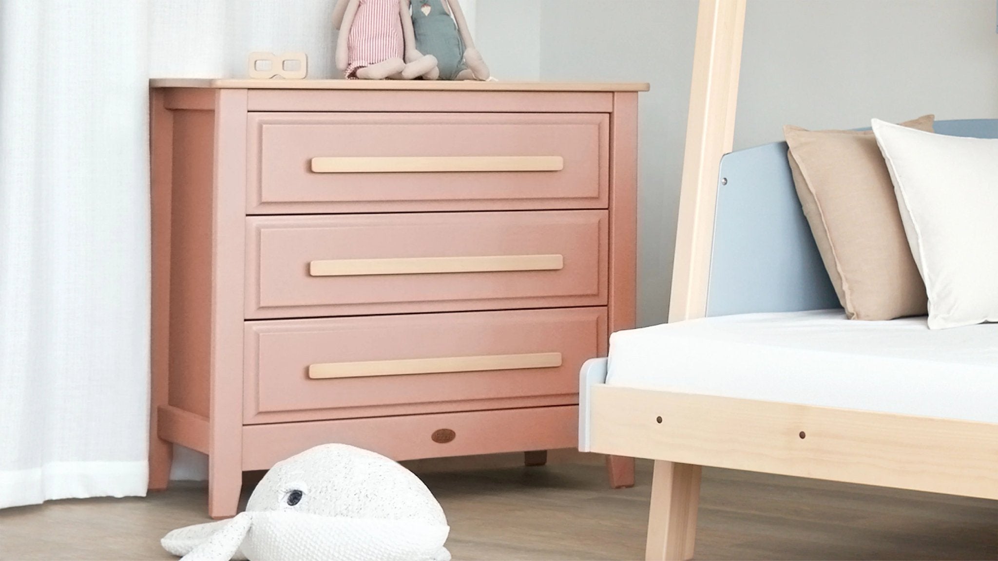 pink chest of drawers with cuddly toys