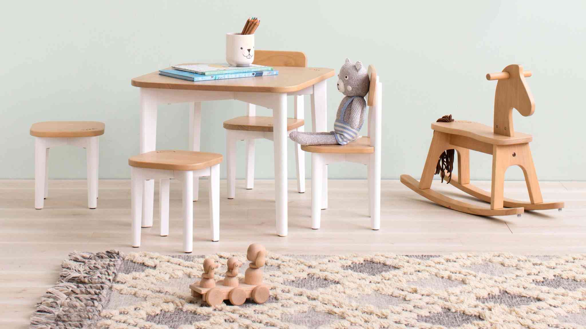 kids table and chair set in playroom with toys and rocking horse