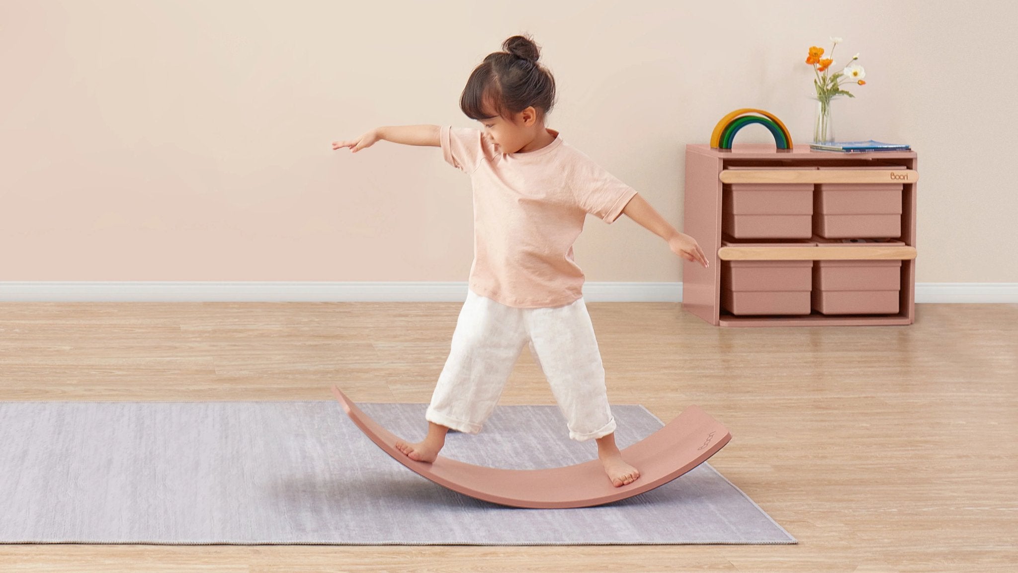 girl balances on pink balance board