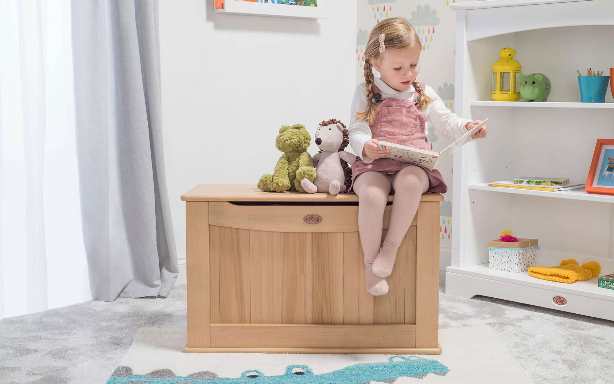 Girl sitting on Toy Box