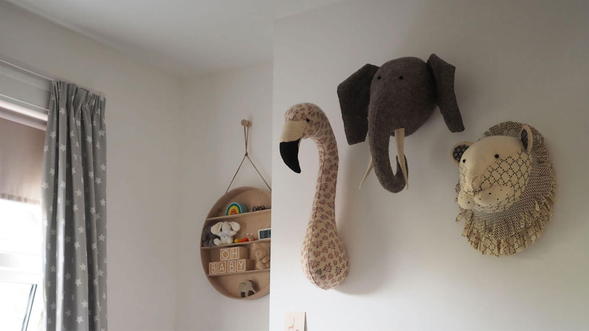 3D toy animal heads mounted to wall