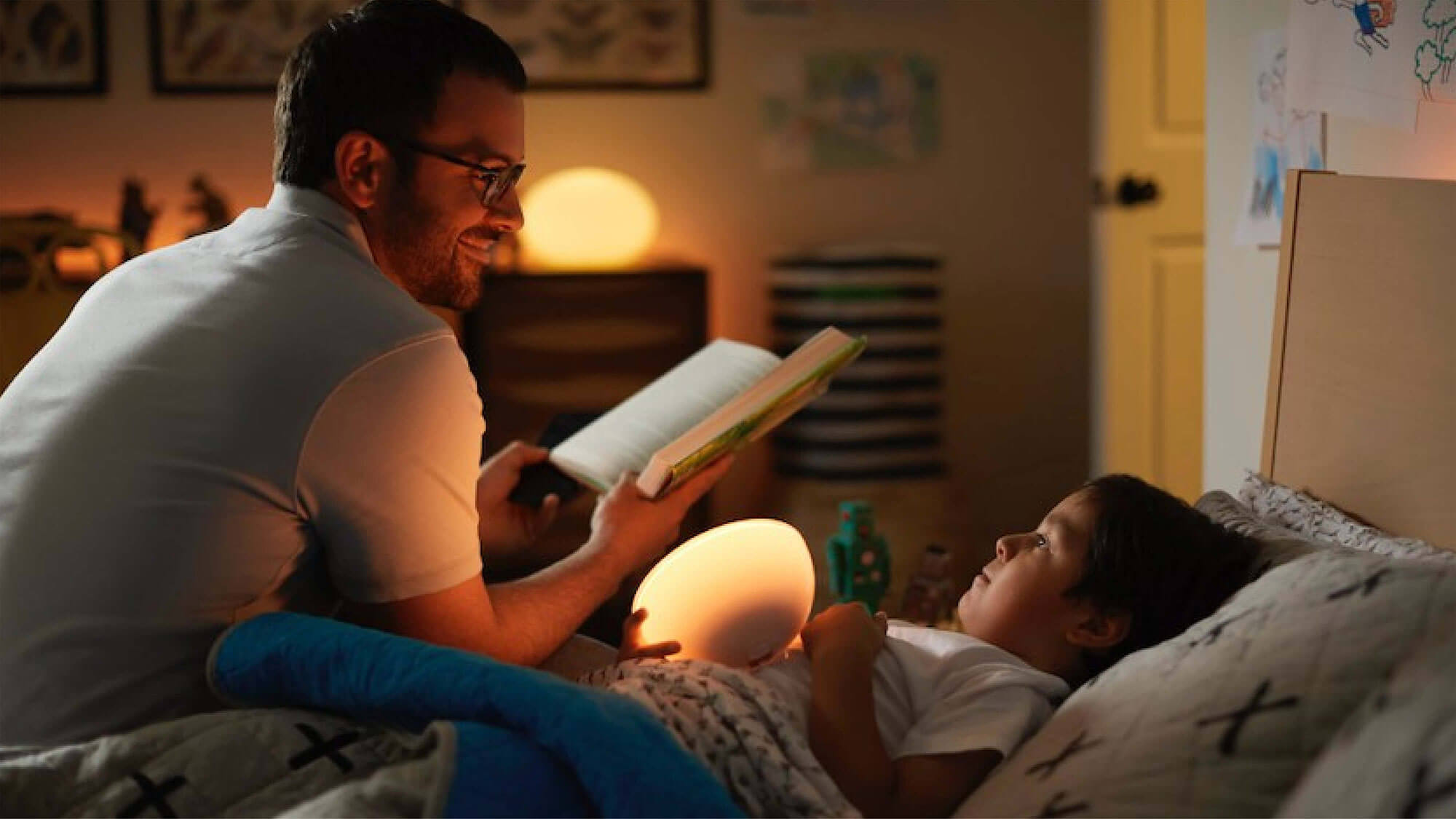 Dad reading with a night light