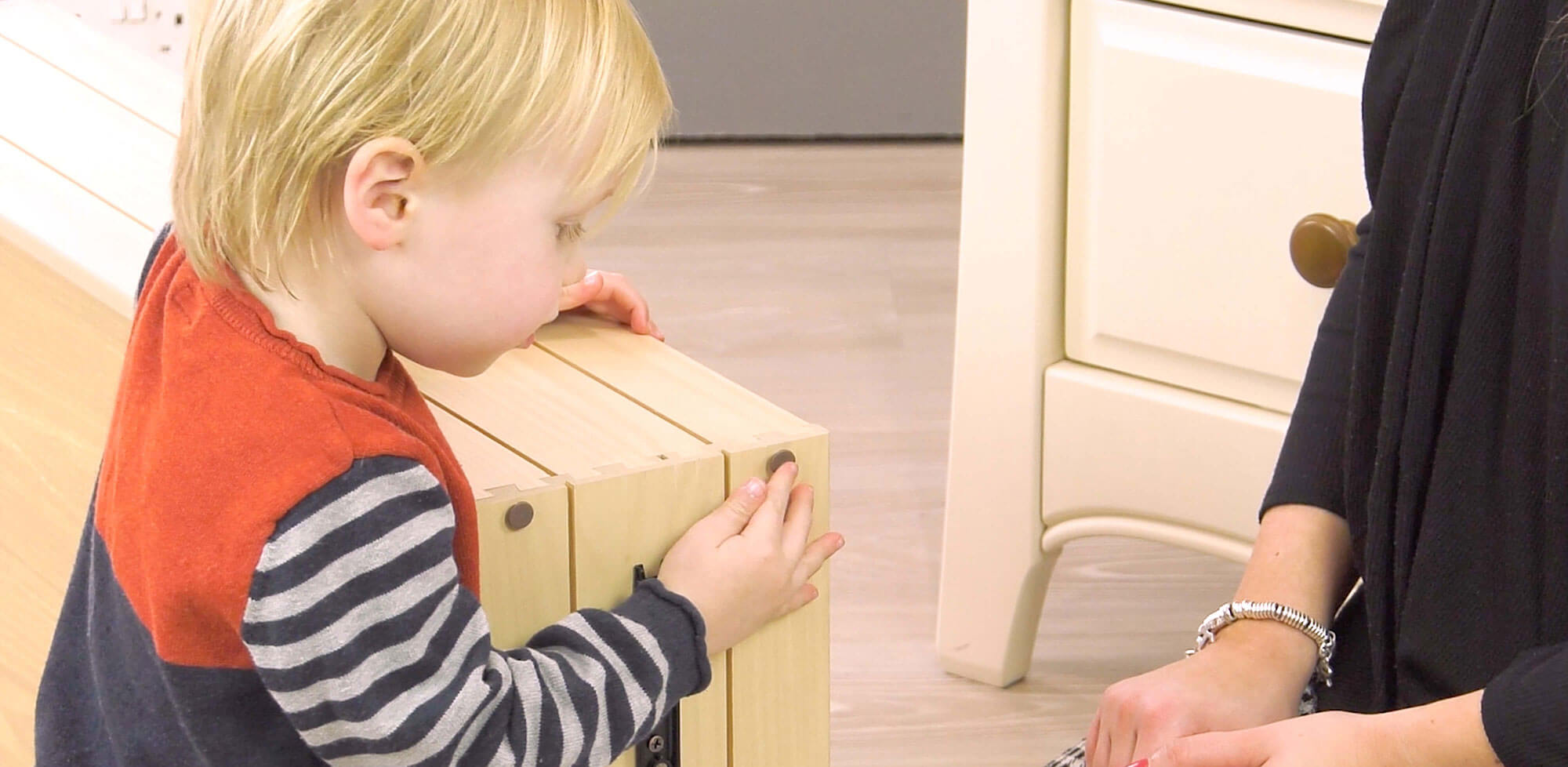 Child helping assemble chest of drawers