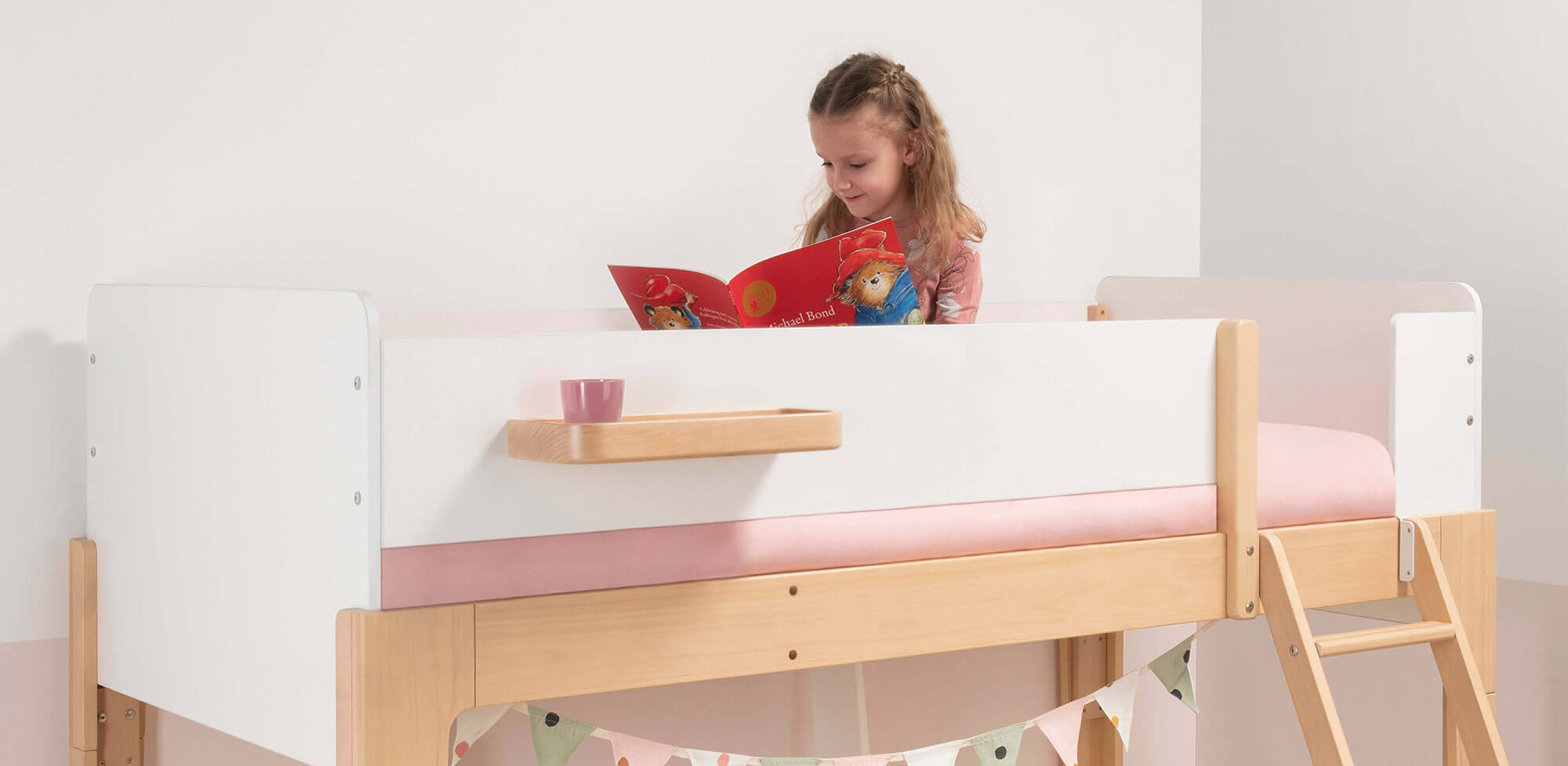 girl reading in top bunk