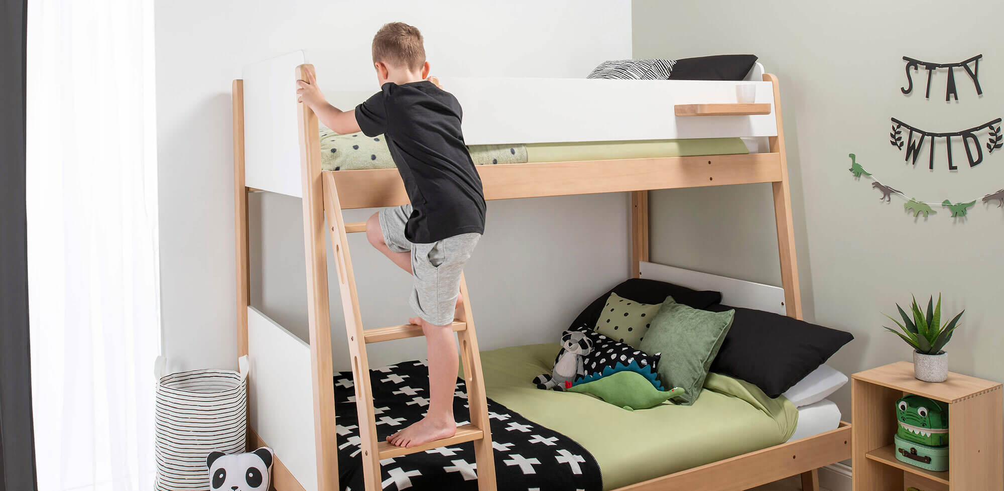 Boy climbing up bunk bed