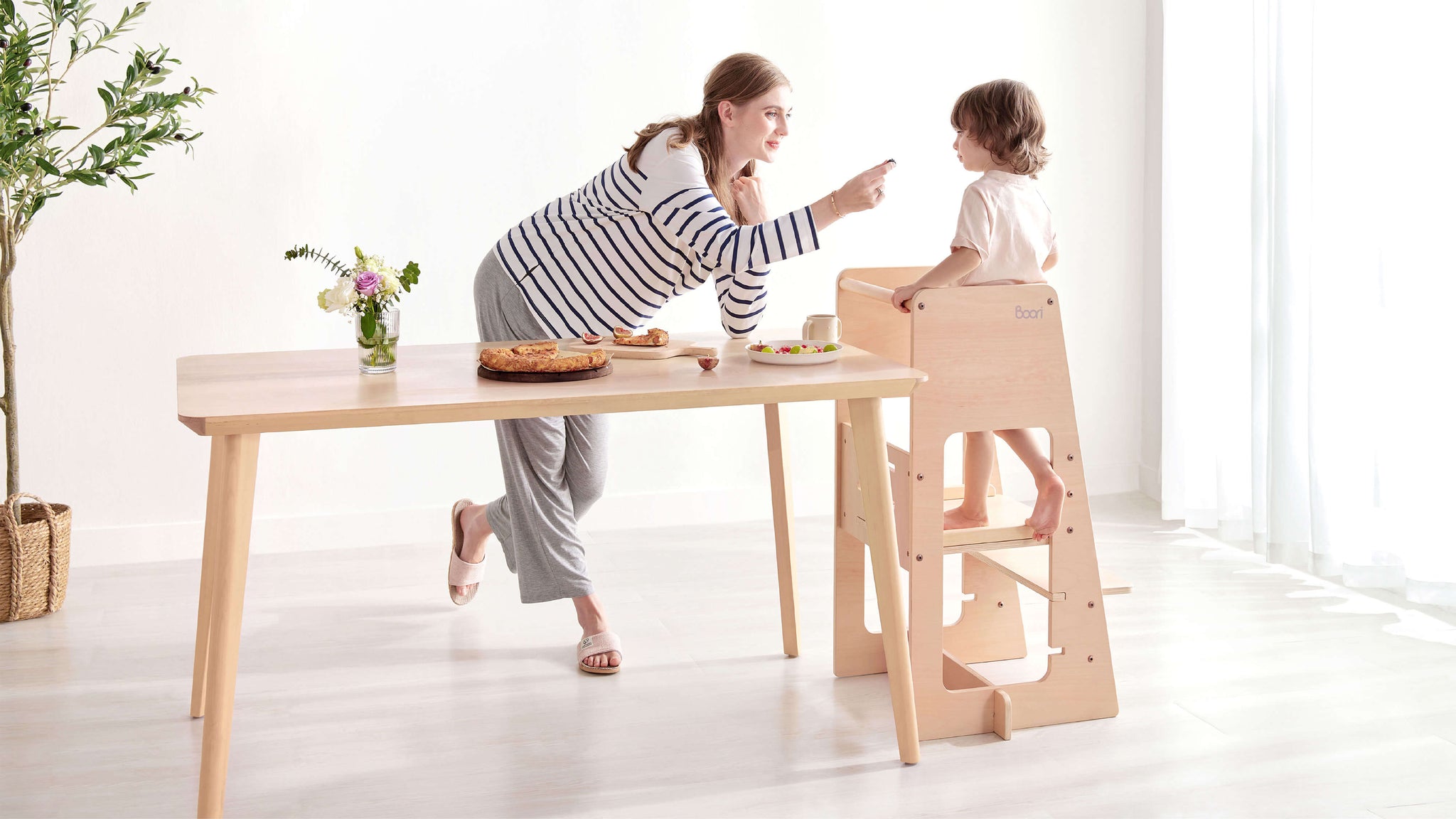 Mum and child at dining table, child using Tidy Learning Tower.