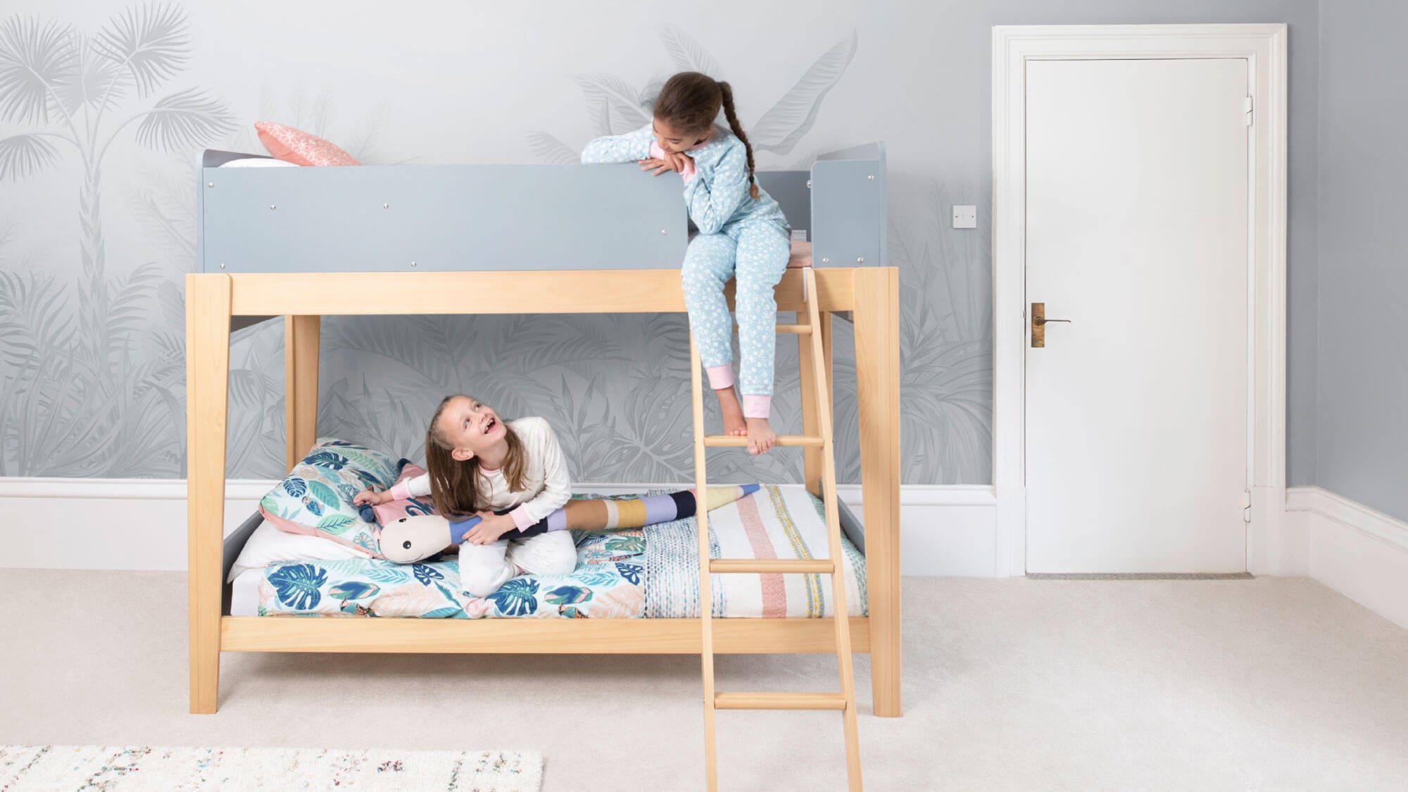 Two teenage girls in blue bunk bed