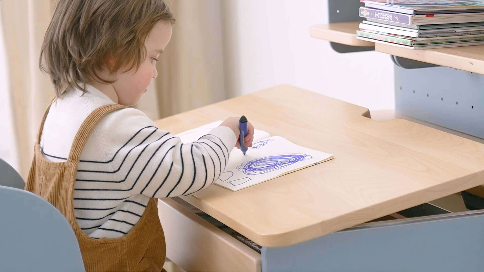 Child drawing on Ergonomic Kids' Desk