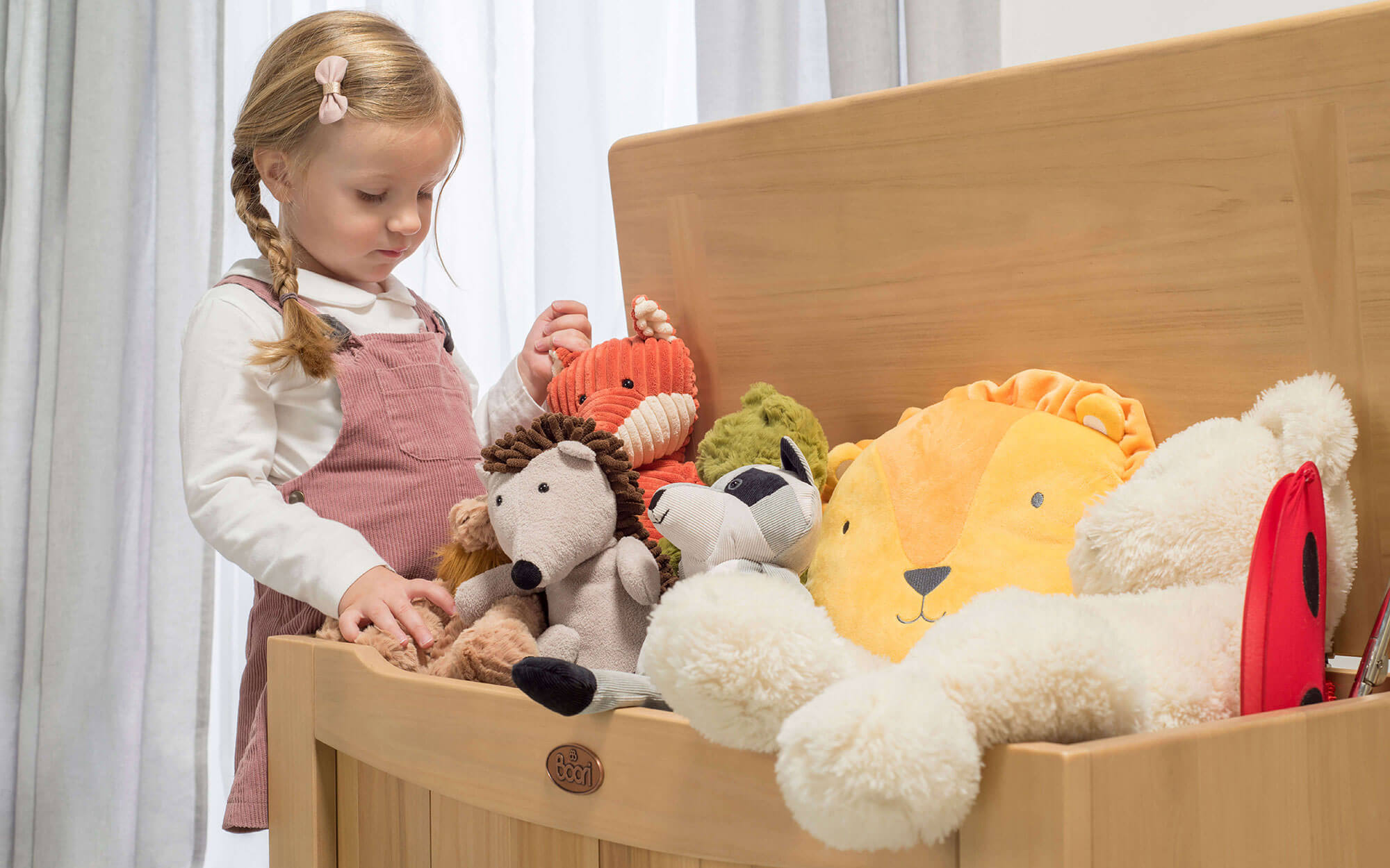 Girl looking into toy box