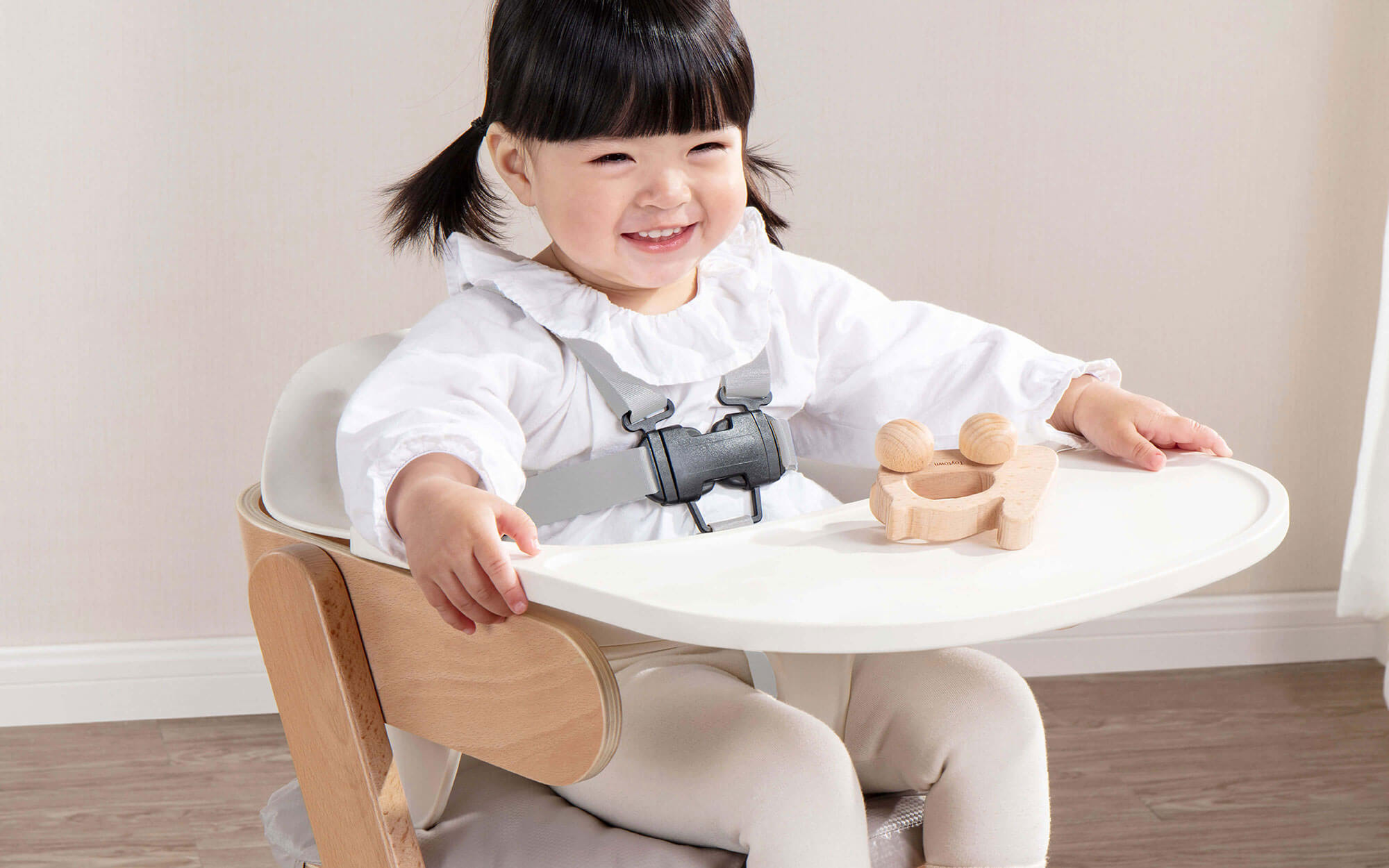 Toddler in highchair with safety strap