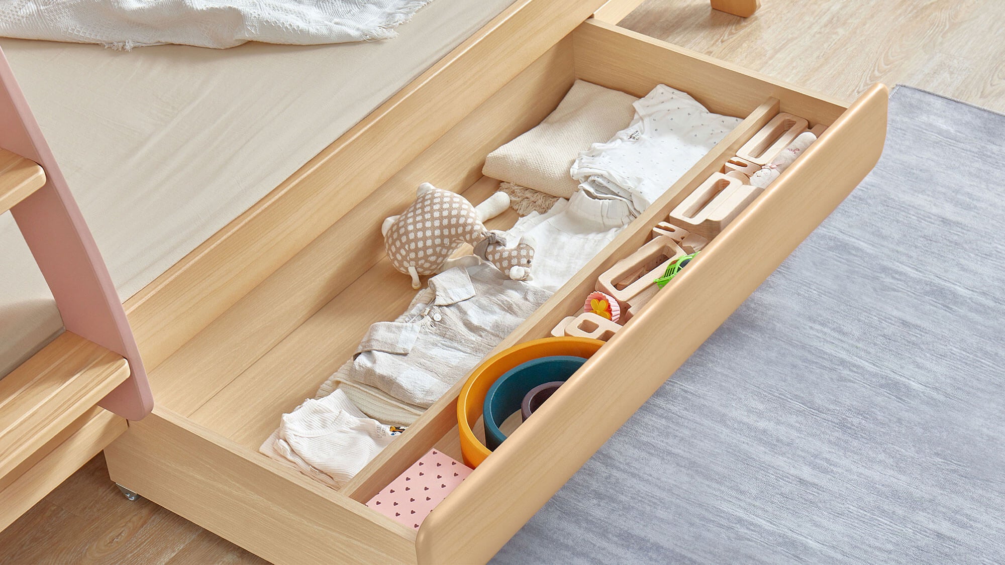 Avalon under-bed drawer with clothing and toys inside