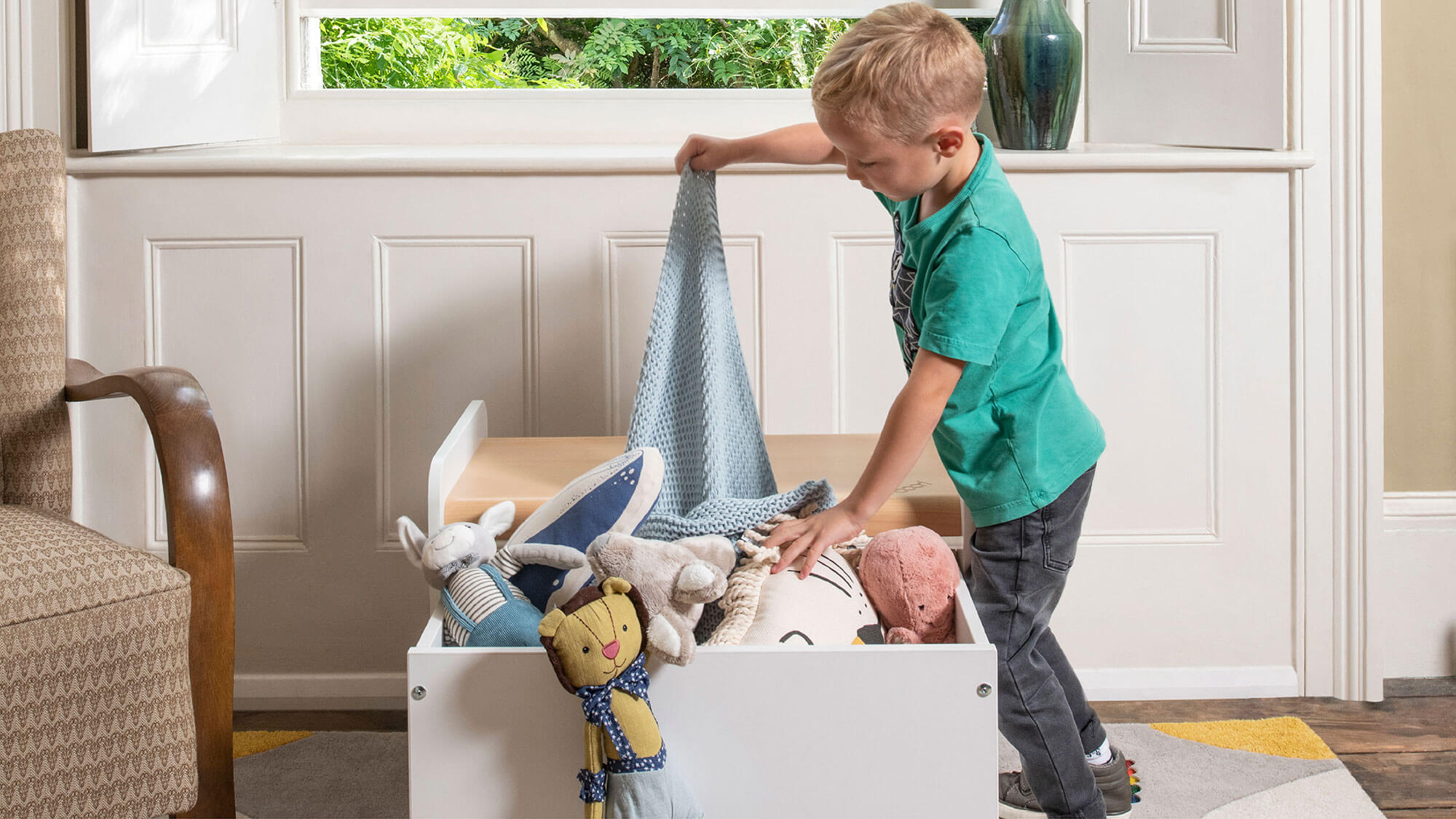 Boy pulling toys out of Tidy Toy Box