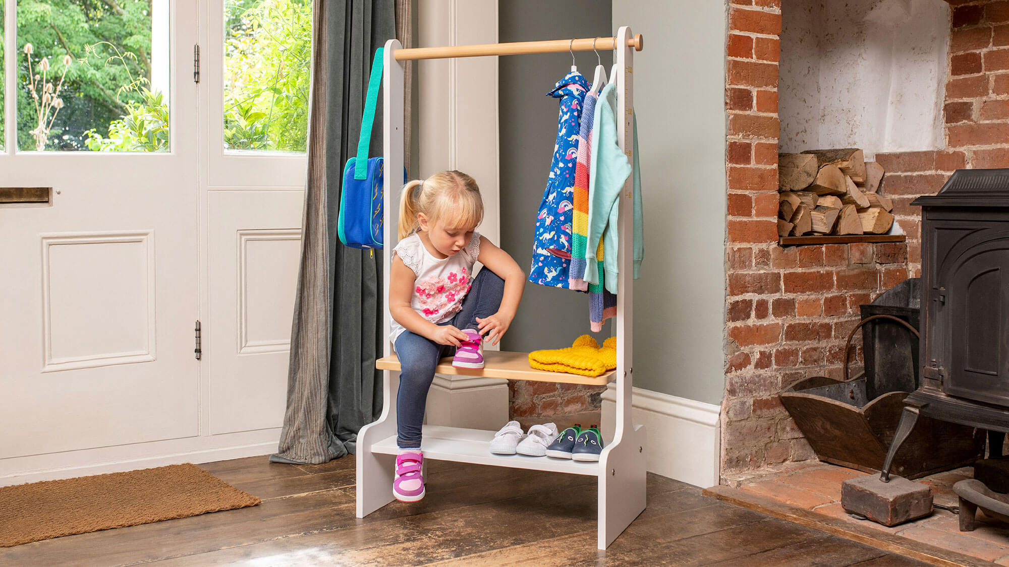 Girl tying shoe on Tidy Clothing Rack