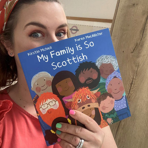 Kirstin McNeil holding a copy of My family is so Scottish