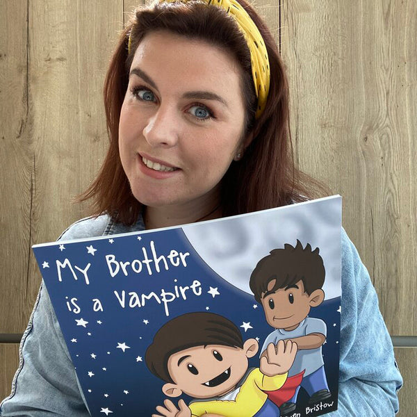 Kirstin holding the "My Brother is a Vampire" Book