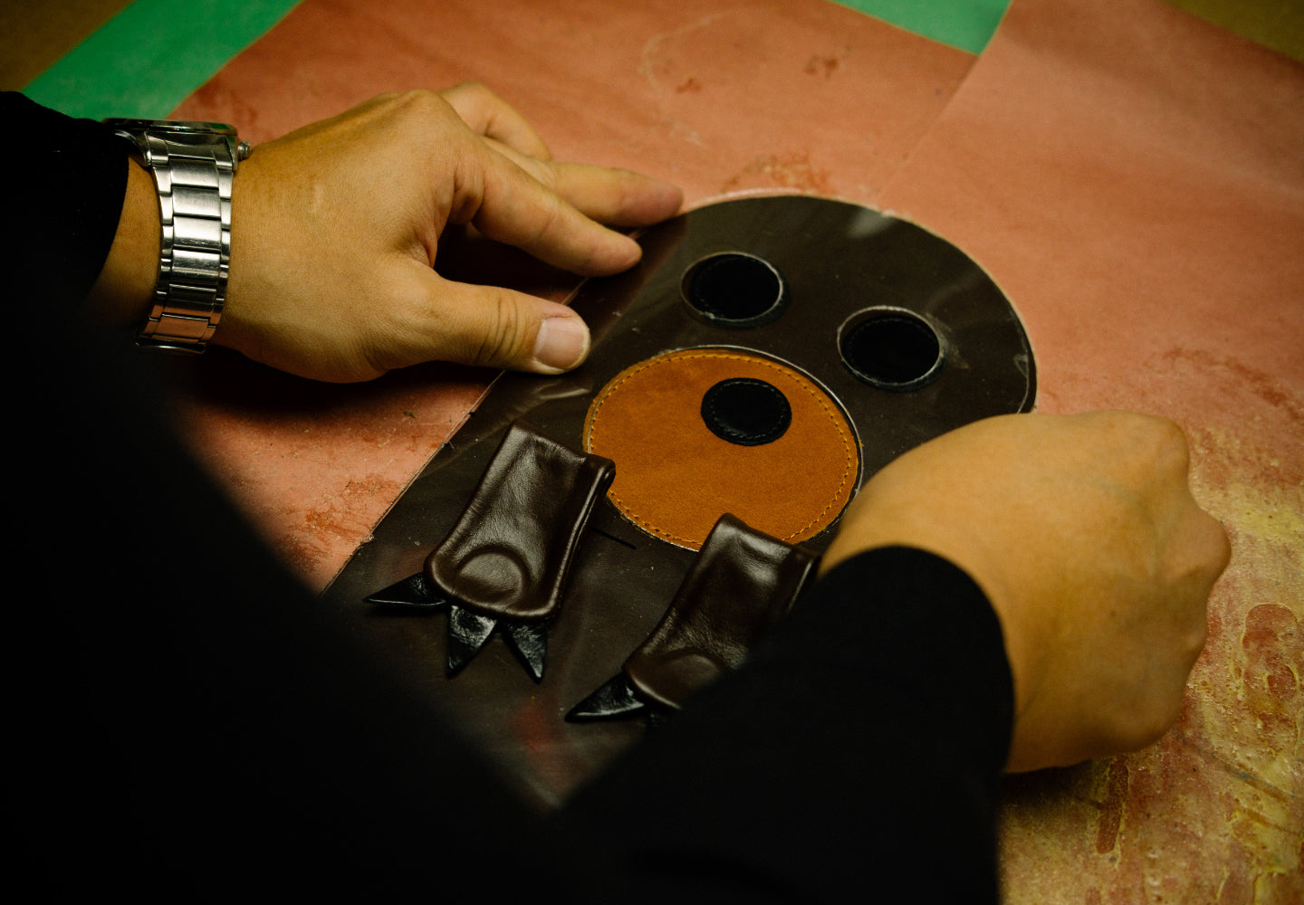A photo of a craftsperson assembling a custom head cover