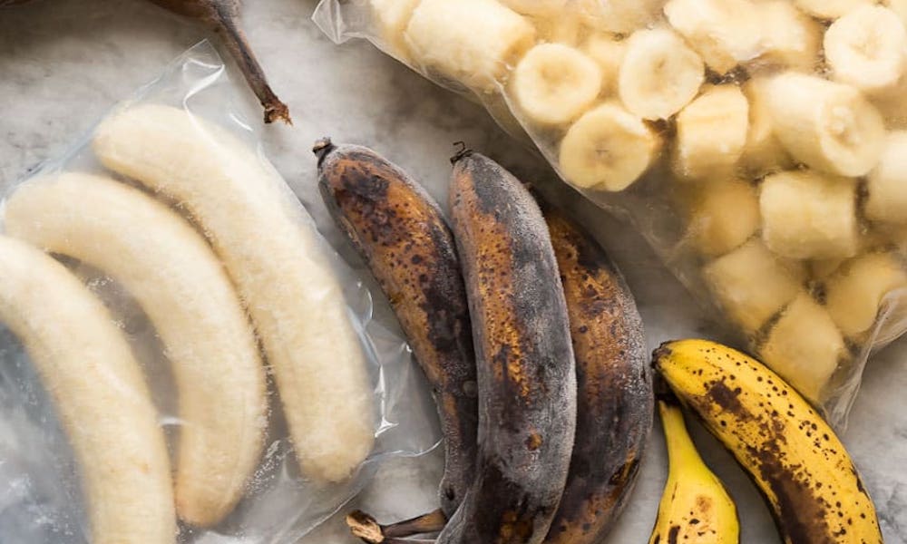 food waste hack showing ripe bananas being frozen for future use