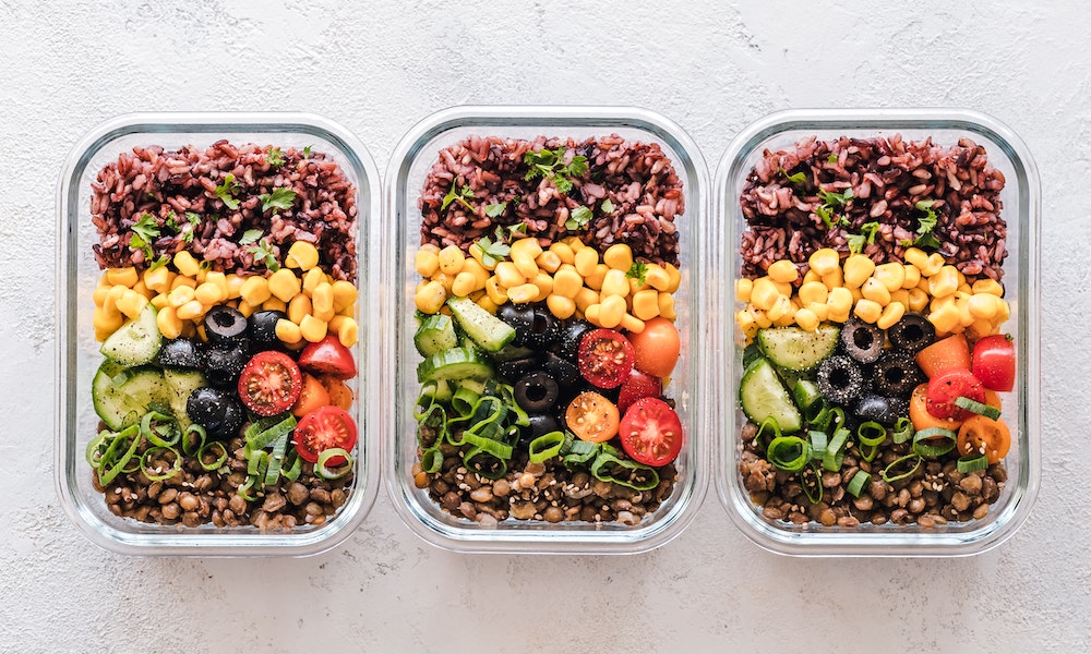 food waste hack showing colourful salads in containers as meal prep
