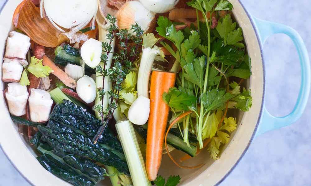 food waste hack showing vegetable scraps in a big pot being turned into stock