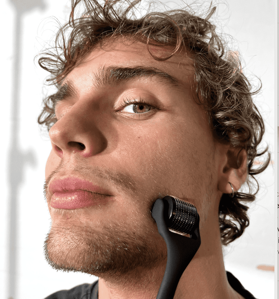 Young man using derma roller from Copenhagen Grooming