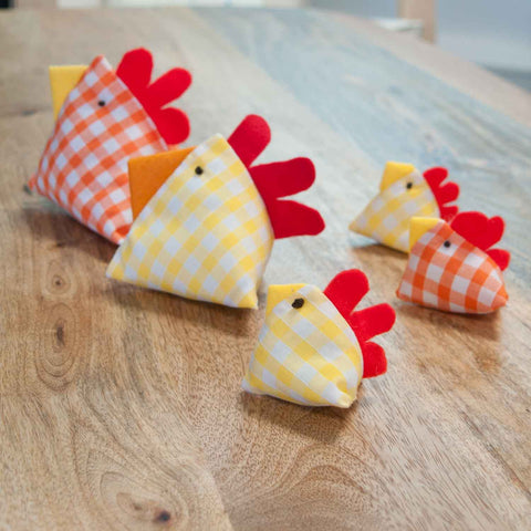 Two large orange and yellow gingham fabric chicks with three baby chicks