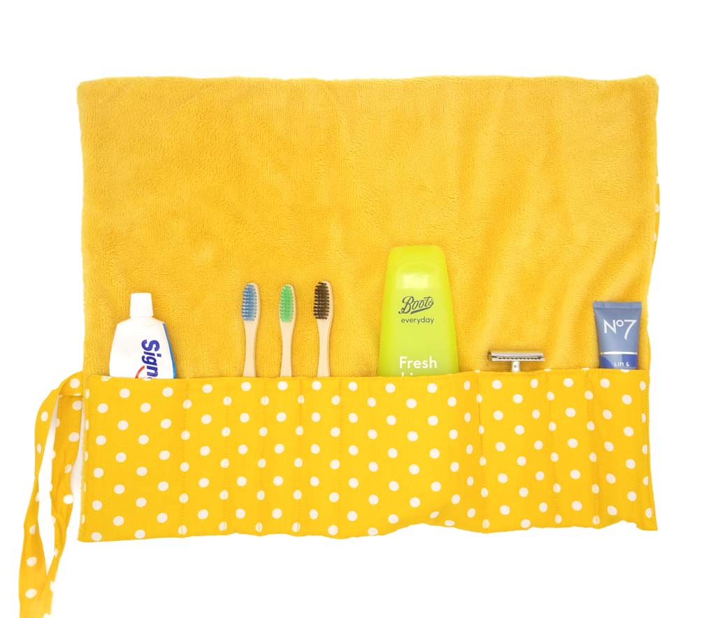 A yellow spotty toiletry wrap with bamboo towelling lining
