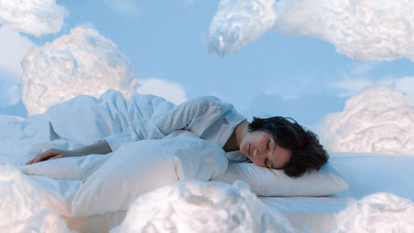 a woman sleeping with clouds all around her