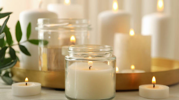 a number of clear glass lit candles on a table