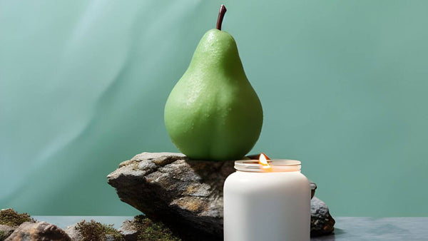 a pear behind a lit scented candle