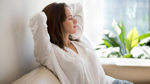 a relaxed content woman sitting on a sofa