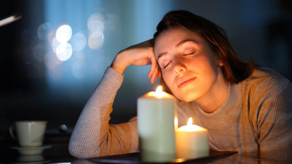 a woman smelling candles