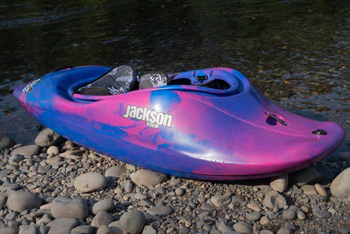 Jackson Kayak Rockstar 5 sitting next to river