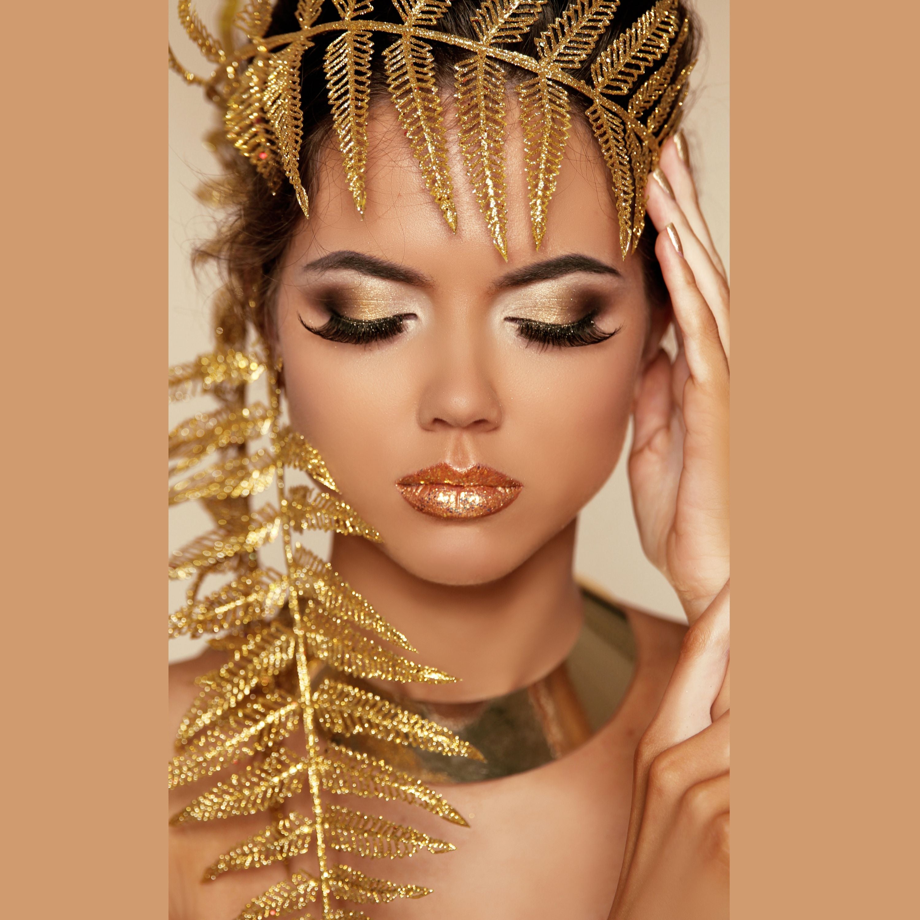 a woman covered in gold leaves