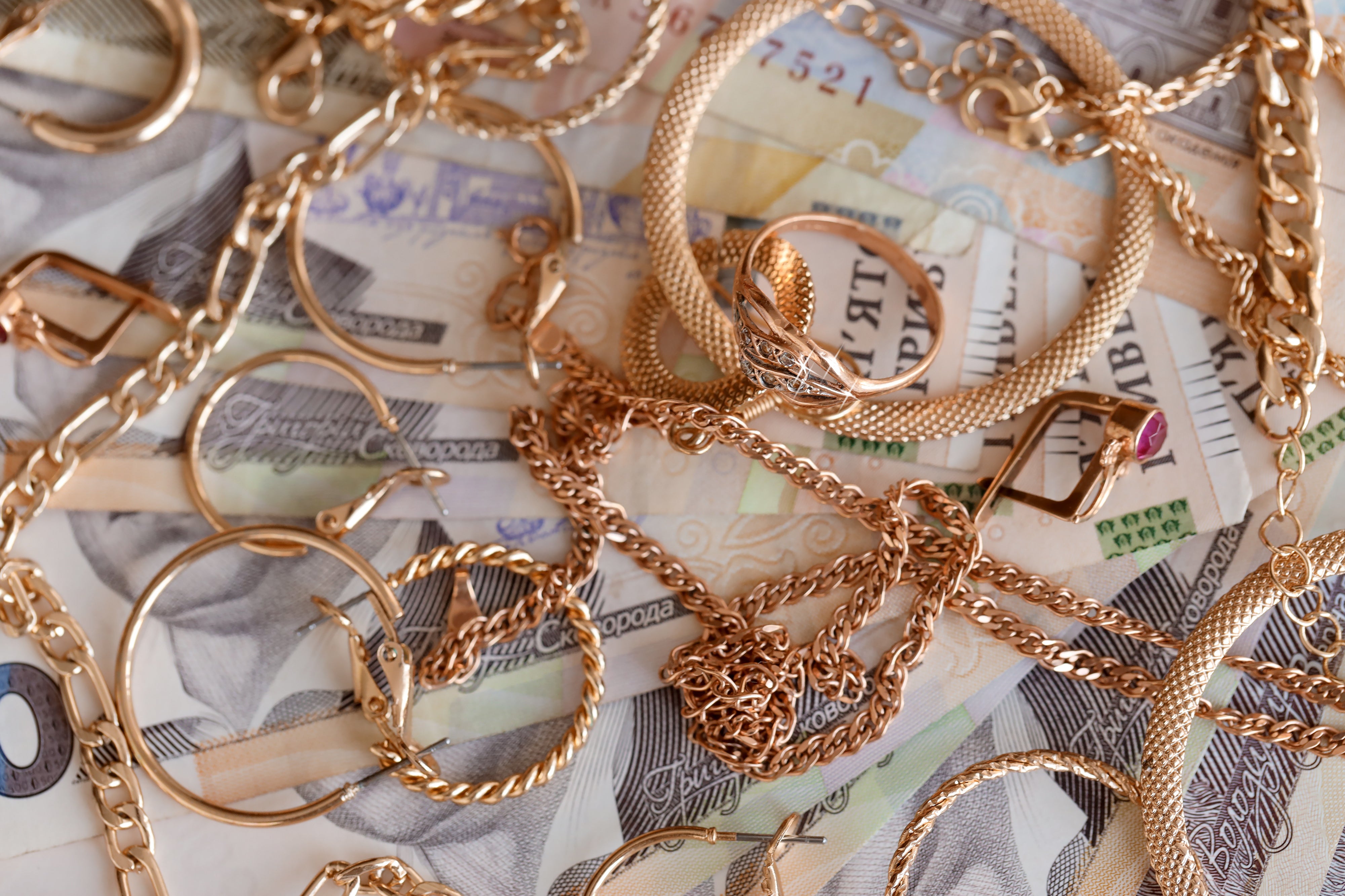 various gold jewelry pieces on a table