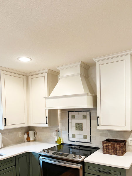 Enamel painted stove hood and kitchen cabinets after transformation. Color Edgecomb Grey by Benjamin Moore