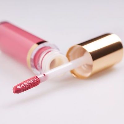 Bottle and applicator for pink tinted hydrating lip balm, for our blog post on revitalizing lips.