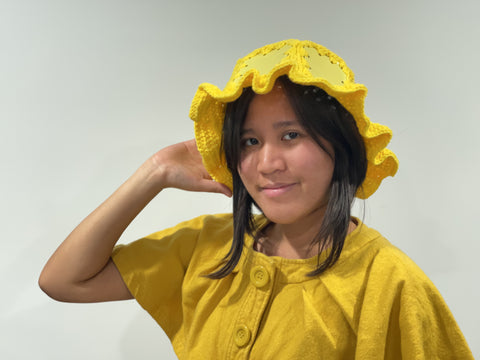 Abbie Dreamer wearing a yellow hat