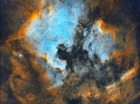 Size and Composition of the Pelican Nebula