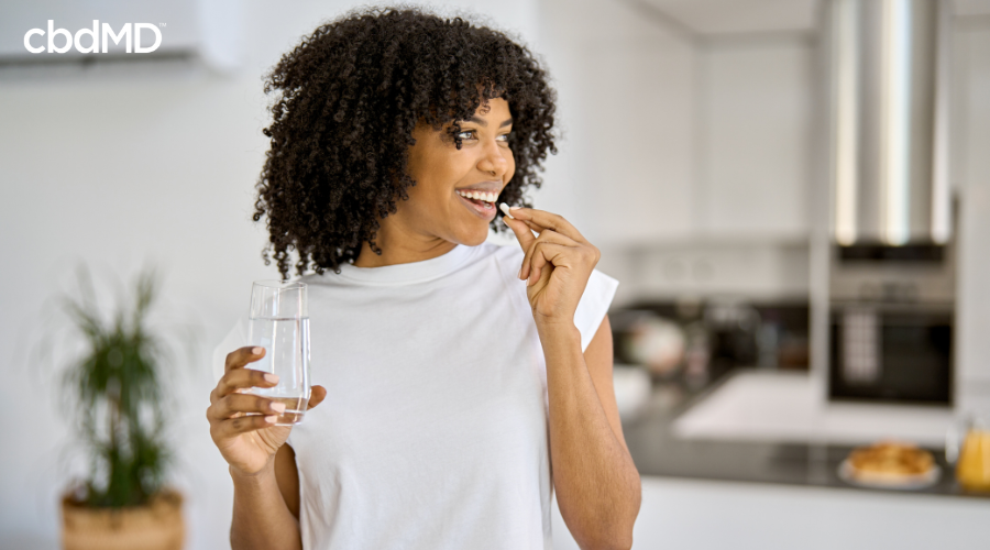 Happy Woman Taking Functional CBD Capsule