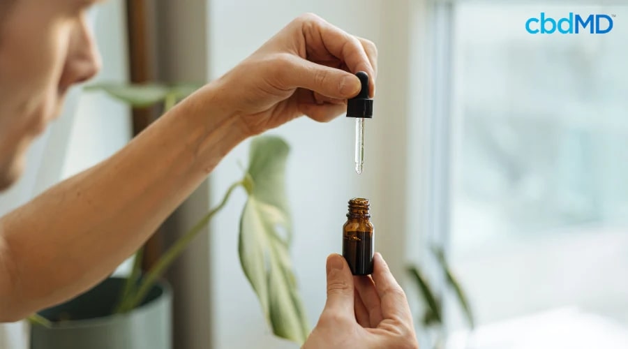 Man Taking cbdMD Tincture as Part of Daily Routine