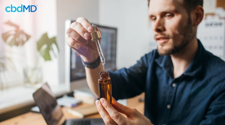 Man Using Legal CBD Tincture from cbdMD