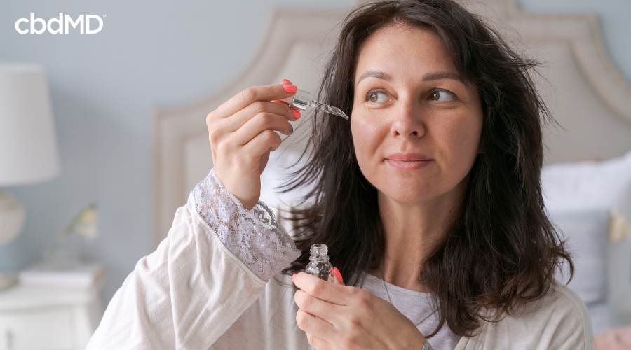 Mother Using CBD Tincture in Wellness Routine