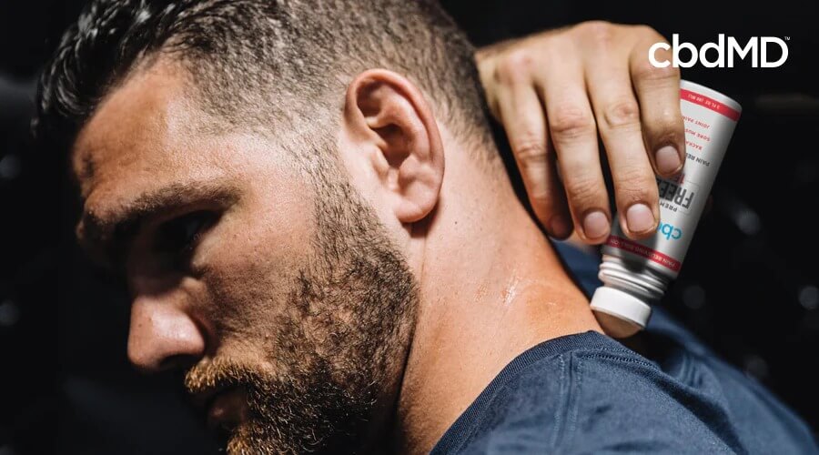 Former MMA champ Mike Bisping rubs CBD Freeze 1500 mg roller on the back of his neck