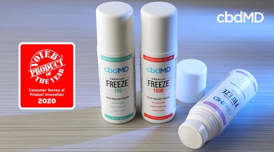 Roll on bottles of award winning cbd freeze from cbdmd in 300, 750, and 1500 mg sits on a wooden table