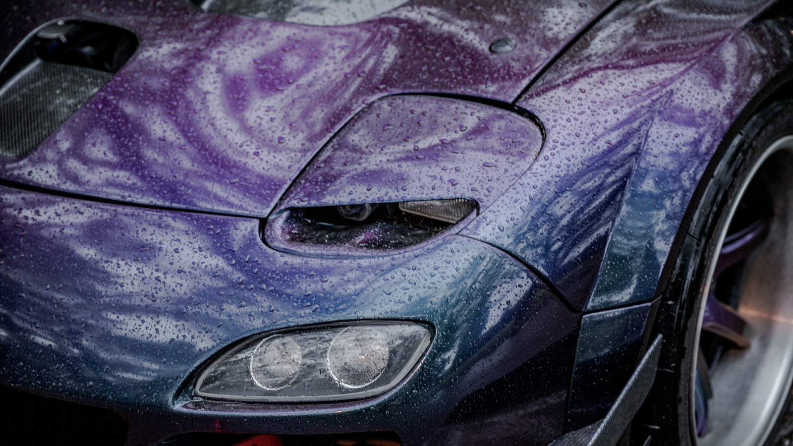 Blue-purple chromatic car with water-beading properties on its surface.
