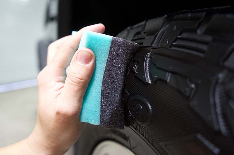 Applying tire shine to tire with the Wonder Wave Durafoam Applicator