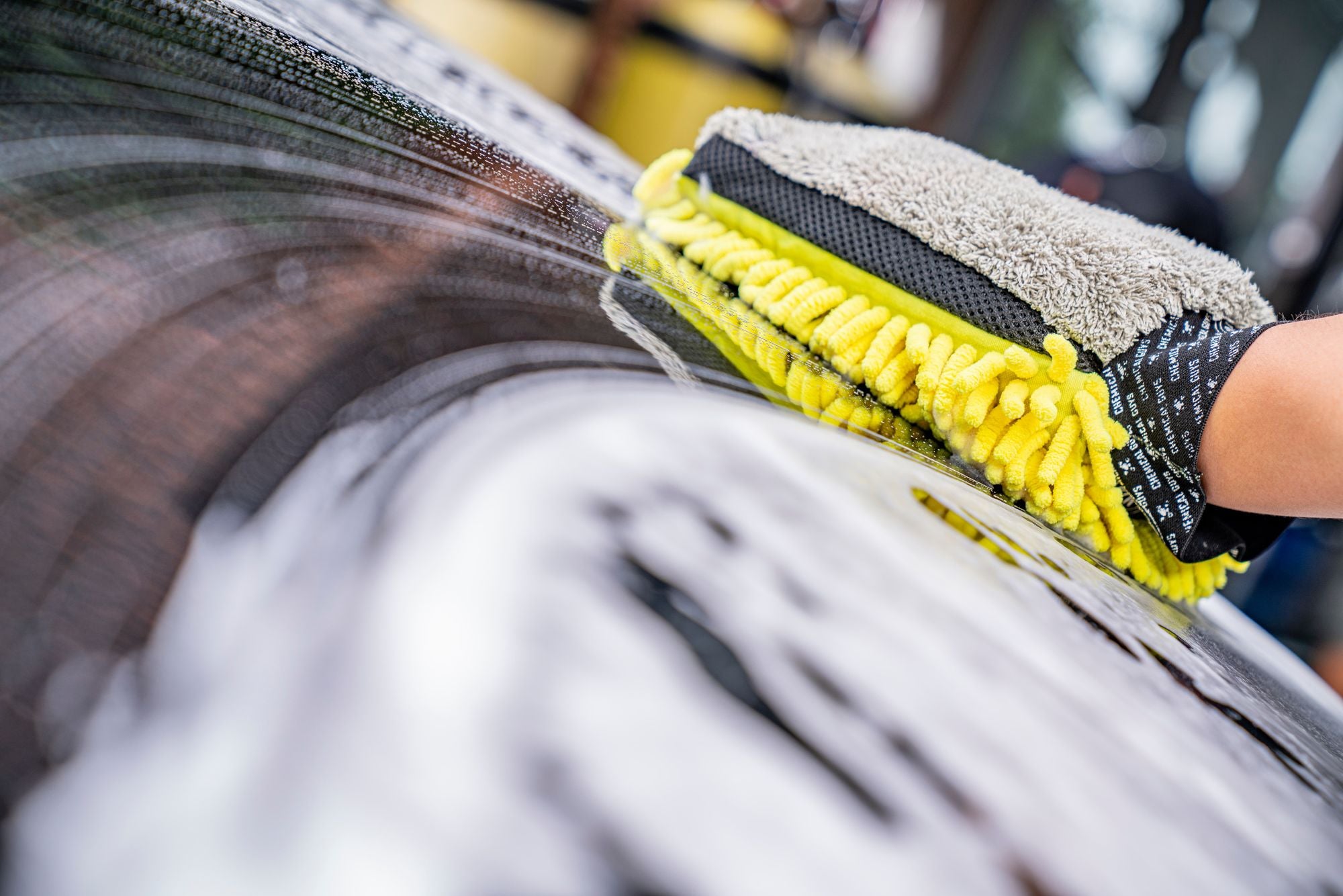 Wiping suds off a car with the chenille side of the 3-Way Premium Wash Mitt.
